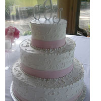 buttercream cake with scrolls and fondant pearls